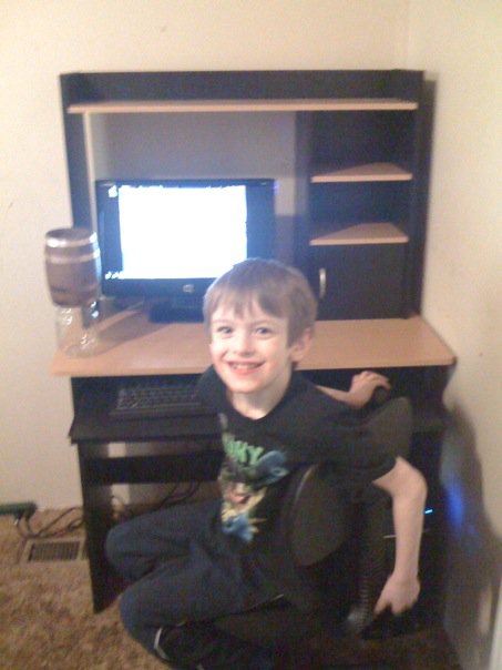 Alex working on a computer at 8 years old